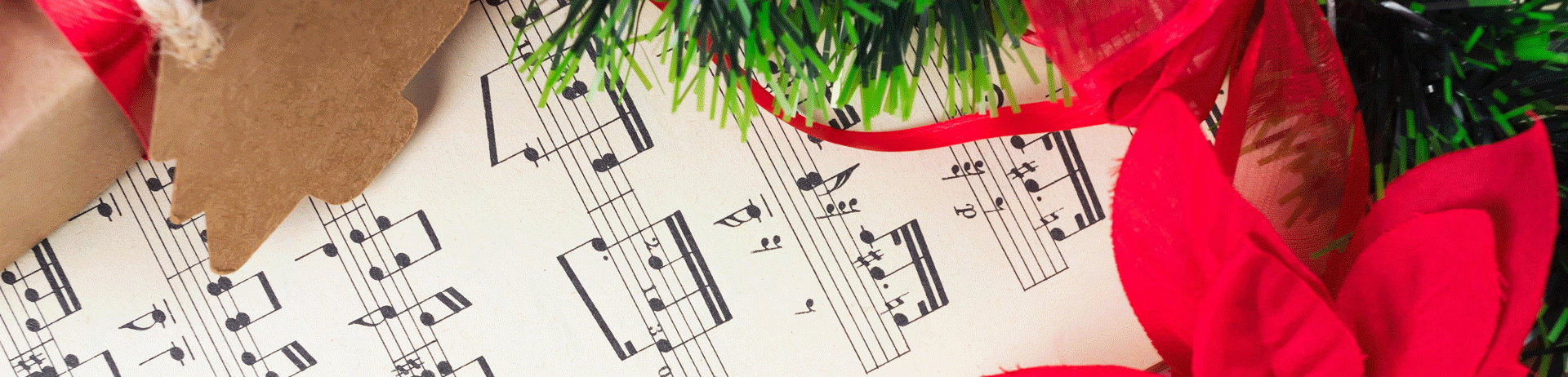 Paper filled with music notes surrounded by poinsettias