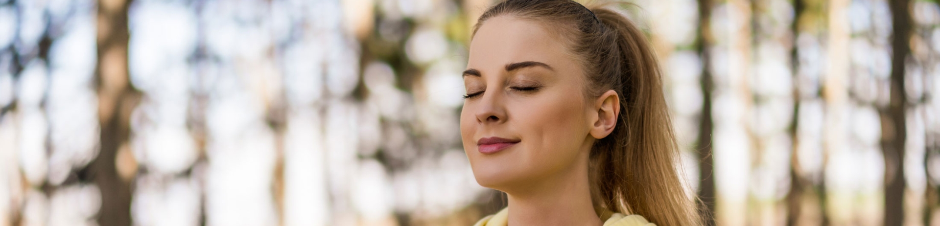 woman meditating in forest