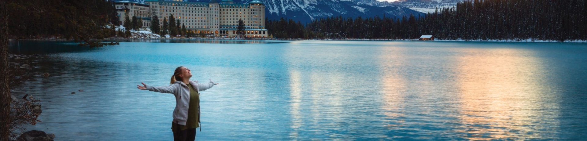 Women standing lake shore of Lake Louise