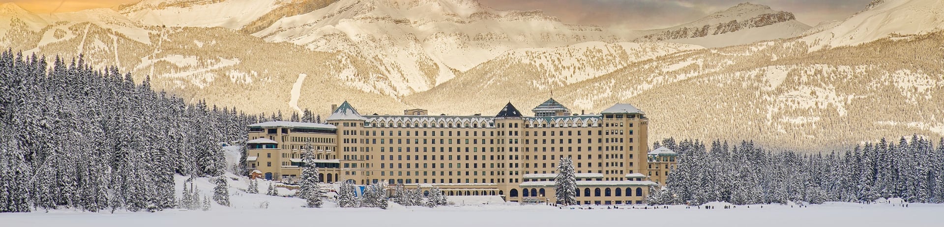 Winter Hero shot of Fairmont Chateau Lake Louise from the frozen snow covered lake