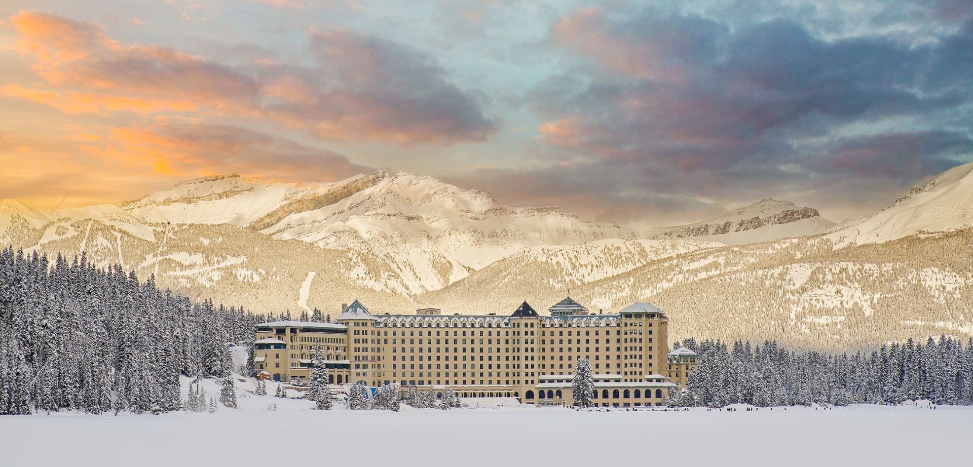 Winter Hero shot of Fairmont Chateau Lake Louise from the frozen snow covered lake